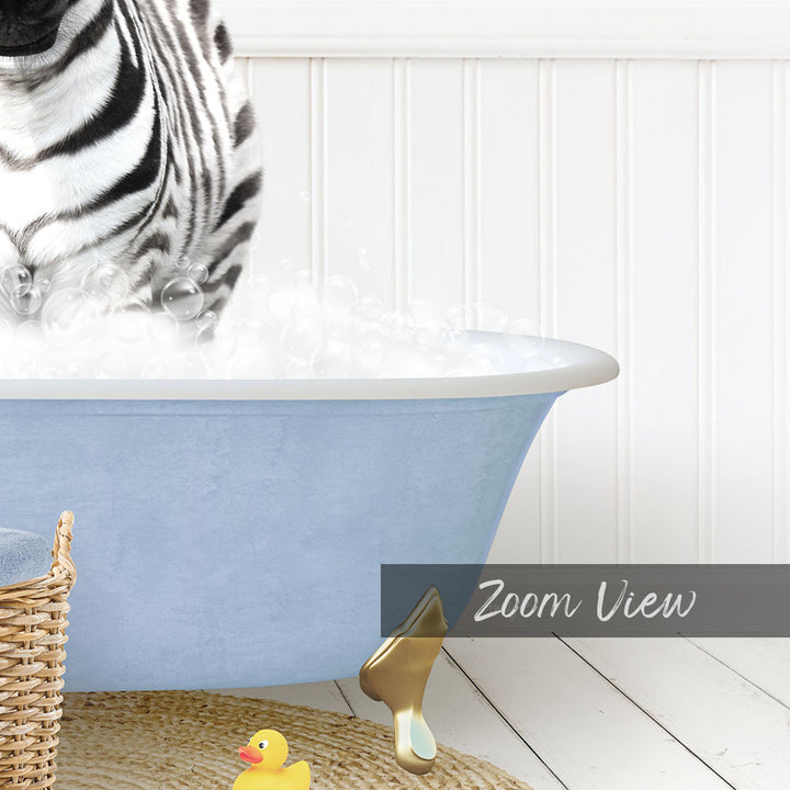A zebra standing in a blue bathtub filled with bubbles, with a yellow rubber duck and a basket nearby.