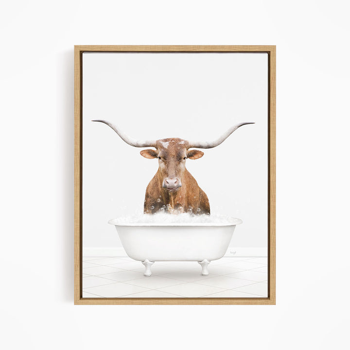 A brown steer with long horns is standing in a white bathtub filled with water, creating a whimsical and humorous scene.