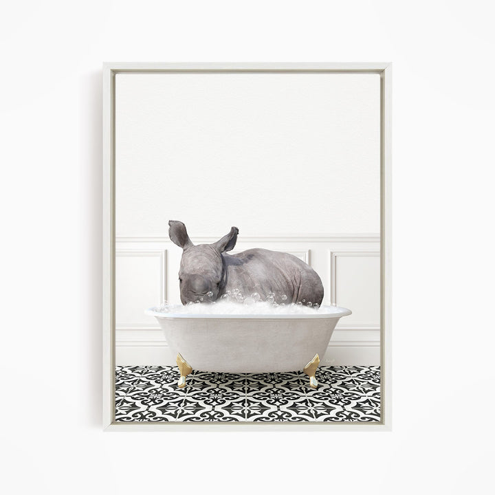 A rhinoceros is sitting in a bathtub filled with water, creating a whimsical and playful scene.