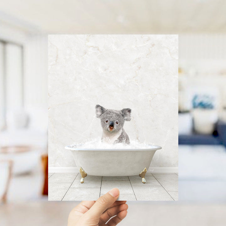 A koala bear sitting in a bathtub filled with water, looking directly at the camera.