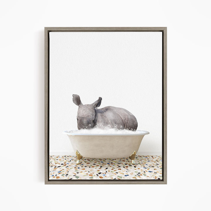 A rhinoceros is sitting in a bathtub filled with water, creating a whimsical and playful scene.