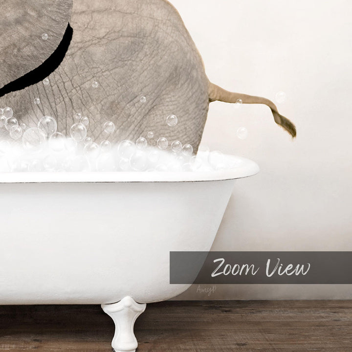 A white bathtub filled with bubbles, with a large elephant's tail submerged in the water.