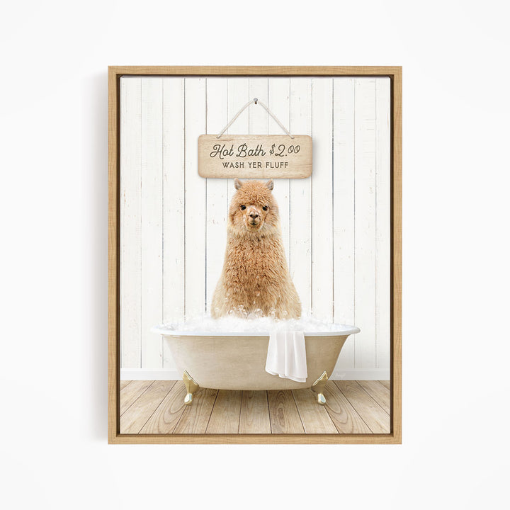 A brown alpaca sitting in a white bathtub, with a wooden sign above it that reads "Hot Bath $2.00 WASH YER FLUFF".