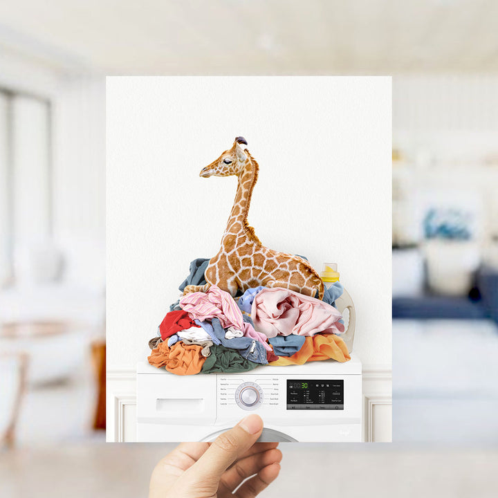 Baby Giraffe on Laundry Clothes Pile on Washing Machine - Simple White Wall
