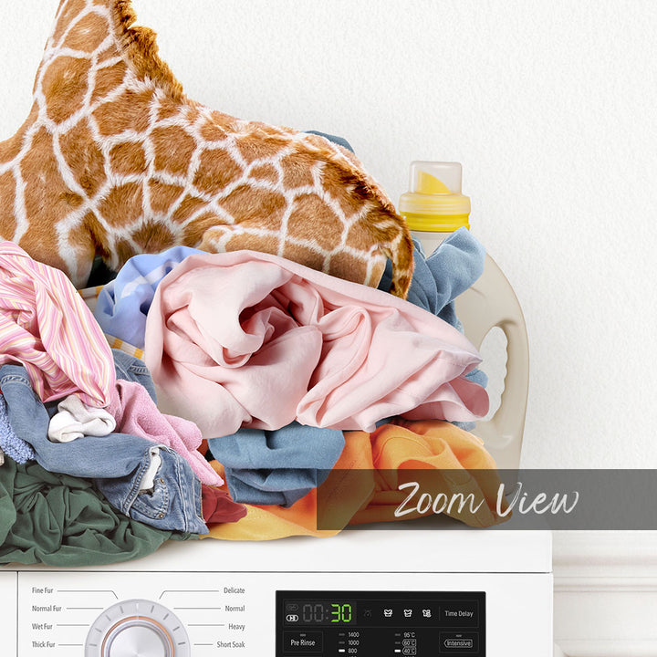 Baby Giraffe on Laundry Clothes Pile on Washing Machine - Simple White Wall