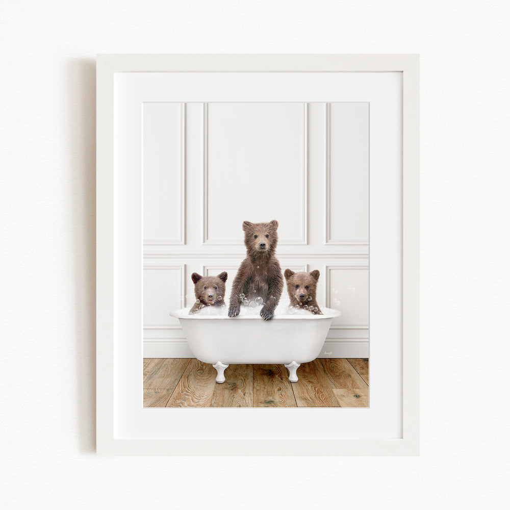A framed image of three bears sitting in a white bathtub, with one bear sitting in the center and the other two bears sitting on either side.