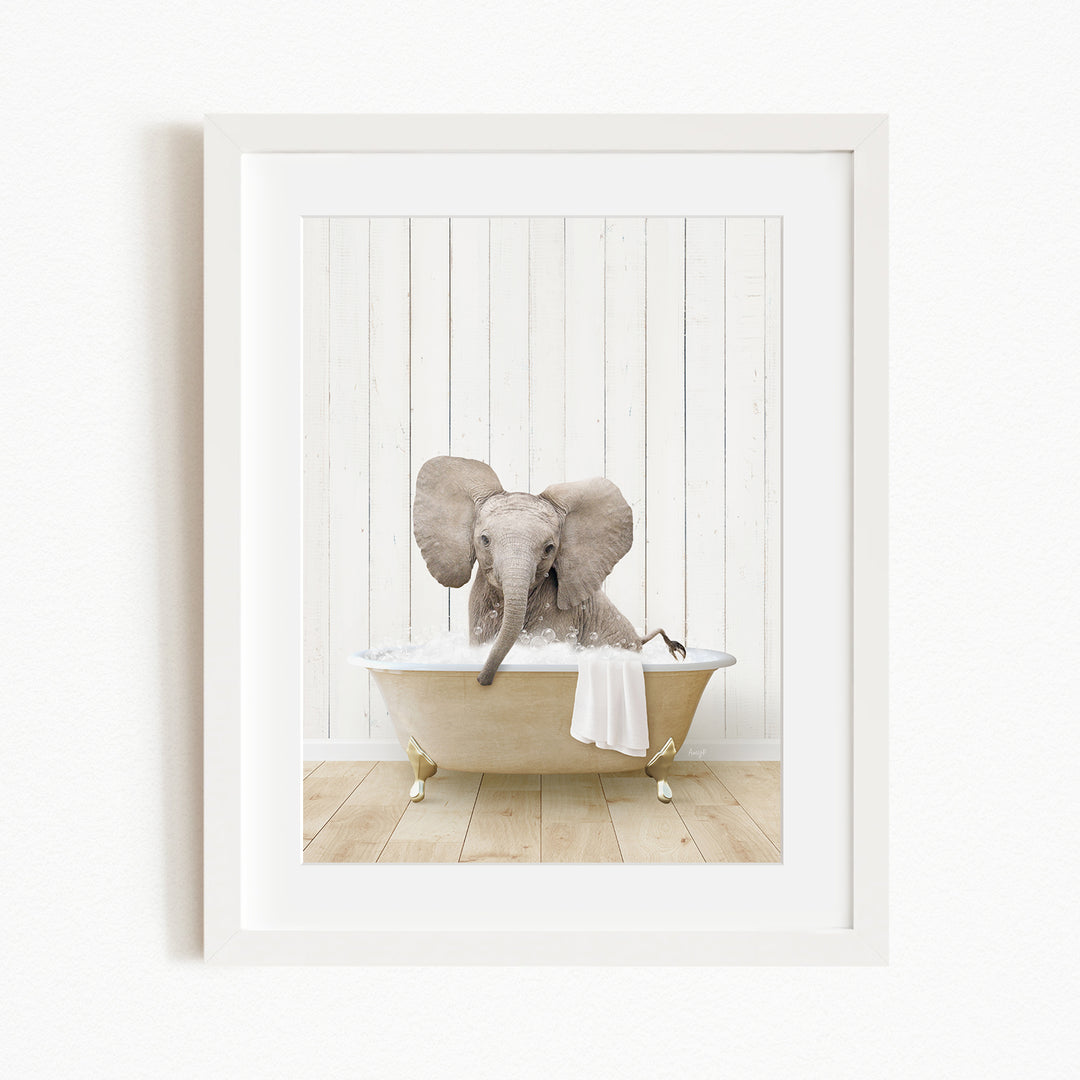 A baby elephant sitting in a bathtub filled with water, surrounded by a white wooden wall.