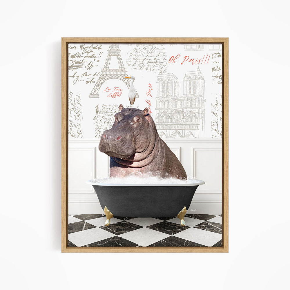 A framed image depicting a hippopotamus sitting in a bathtub, with a bird perched on its head.