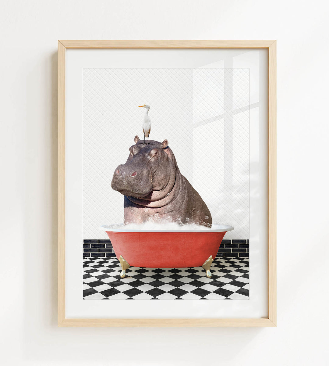 A framed image depicting a hippopotamus sitting in a red bathtub, with a seagull perched on its head.
