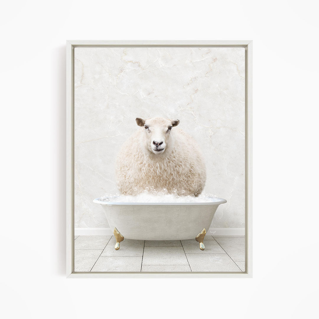A fluffy white sheep sits in a white bathtub, surrounded by a white marble wall.