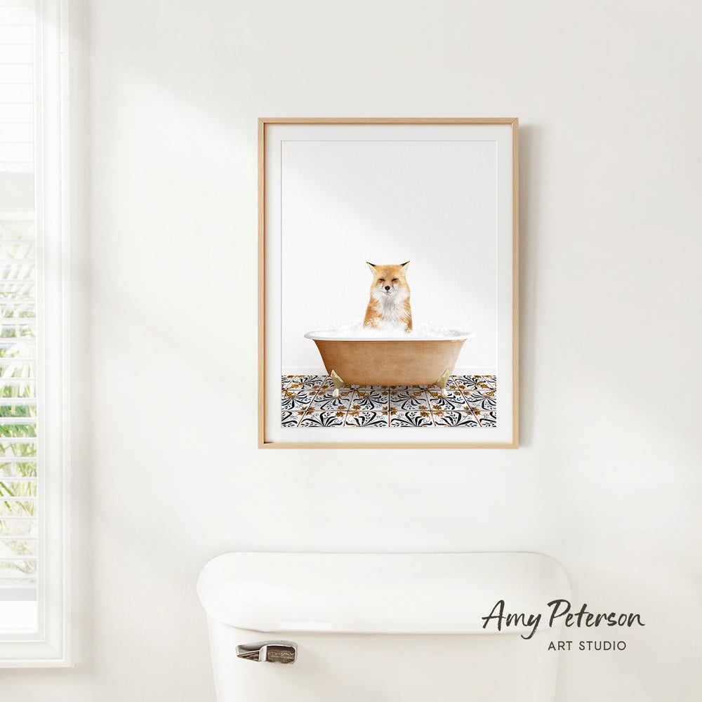 A framed image of a cat sitting in a bathtub, with a patterned tile on the floor.