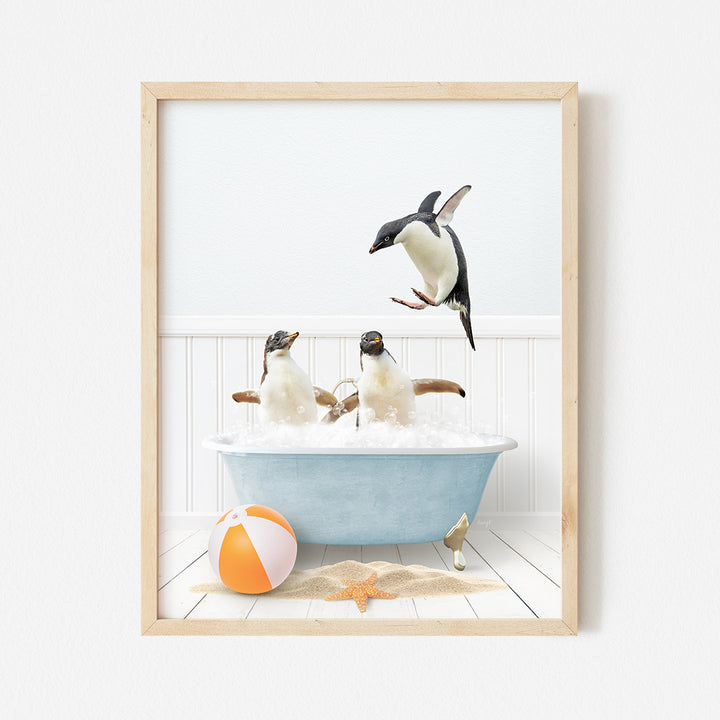 a group of penguins in a bathtub with a beach ball