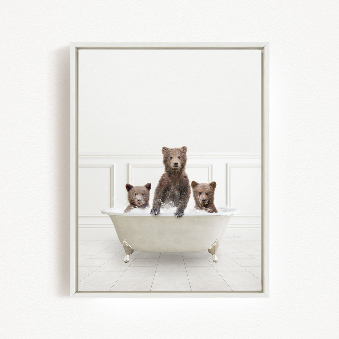 Three adorable brown bears sitting in a white bathtub, enjoying a relaxing bath together.