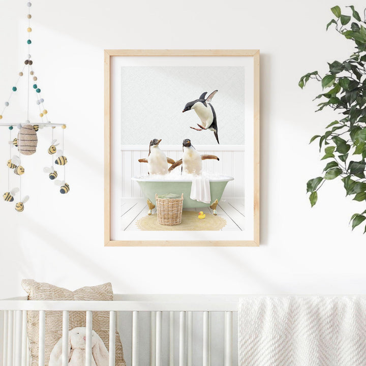 A framed image of two penguins sitting in a bathtub, with one penguin standing on the edge of the tub and the other sitting comfortably in the water.