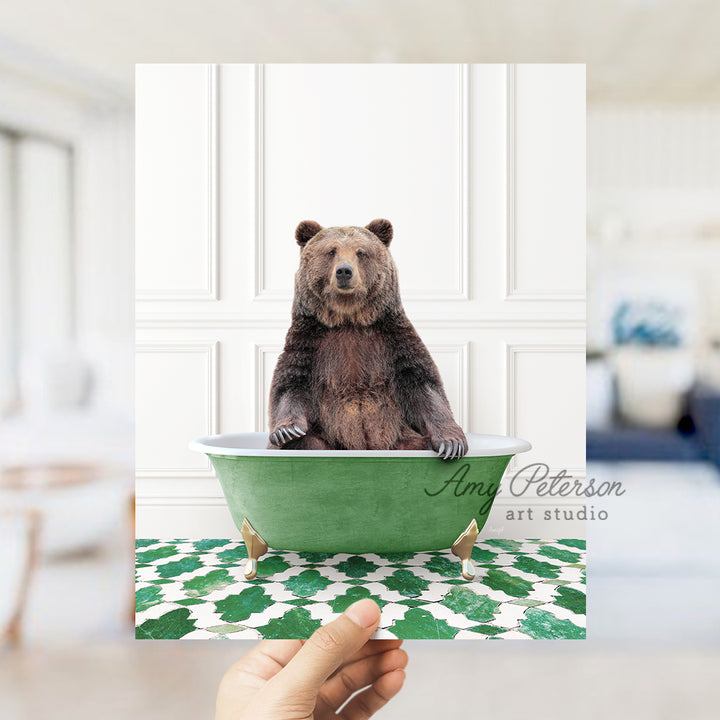 a hand holding a card with a bear in a bathtub