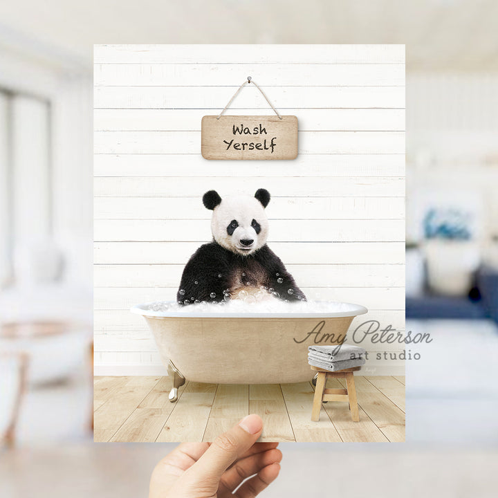 a panda bear sitting in a bathtub with a sign above it