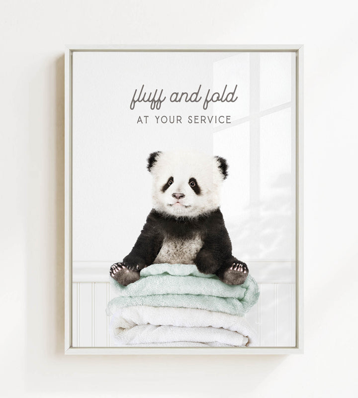 A panda bear sitting on a stack of towels, with the text "fluff and fold at your service" written above the image.