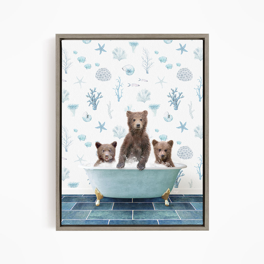 A framed image depicting three bears sitting in a bathtub filled with water, surrounded by a blue and white ocean-themed wallpaper.