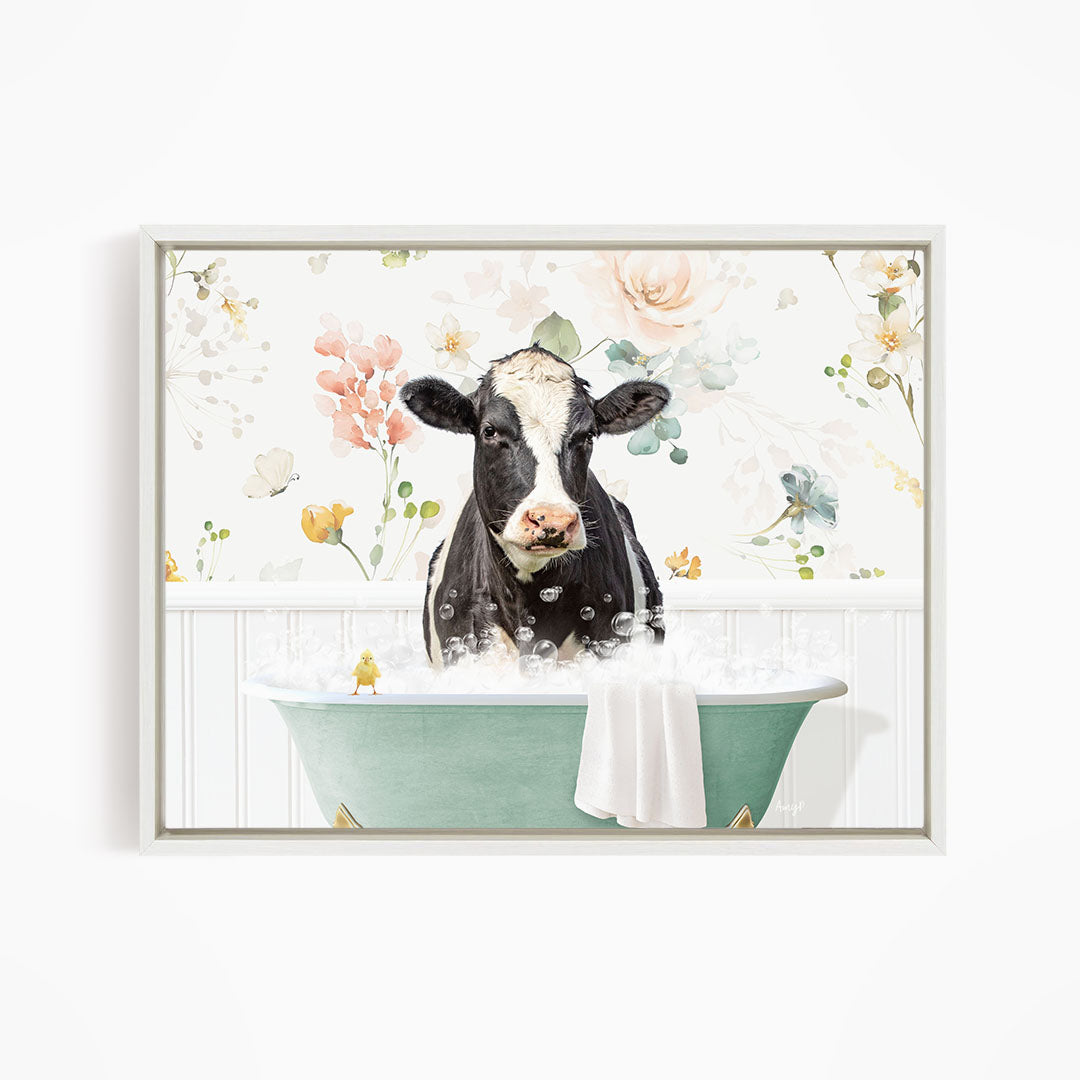 A black and white cow is sitting in a green bathtub filled with bubbles, surrounded by a floral wallpaper.