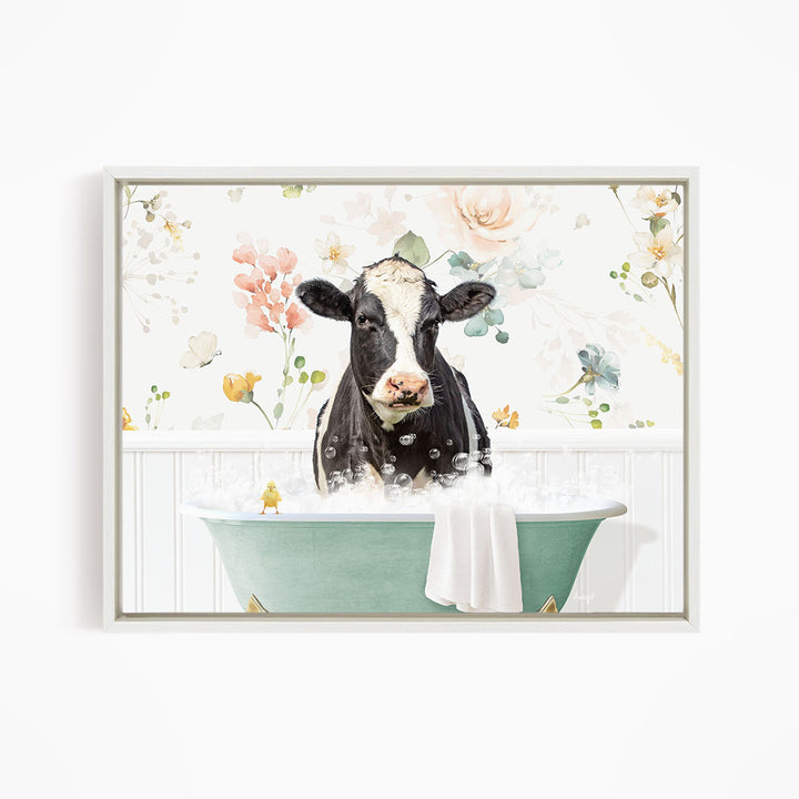 A black and white cow is sitting in a green bathtub filled with bubbles, surrounded by a floral wallpaper.