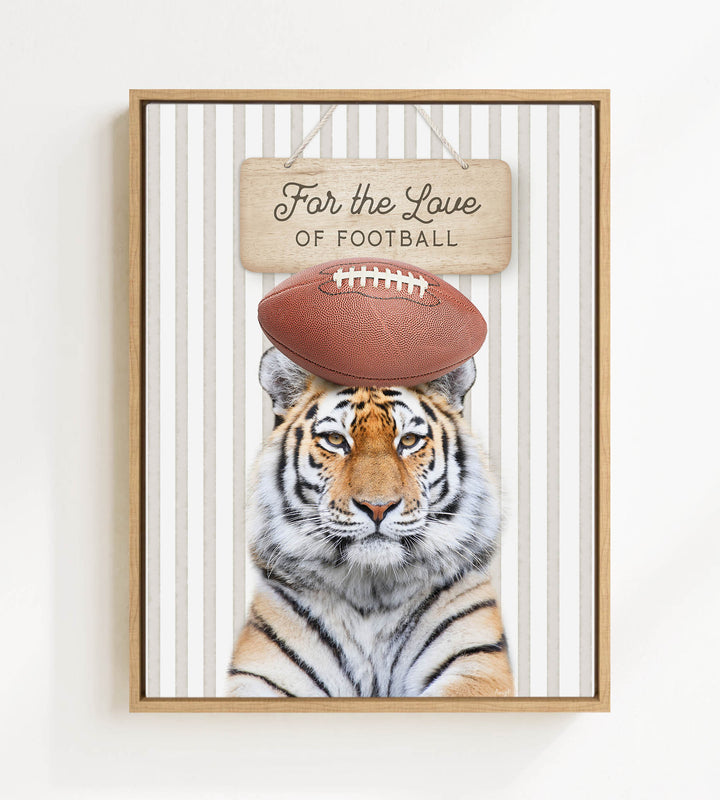 A tiger is standing in front of a sign that says "For the Love of Football".
