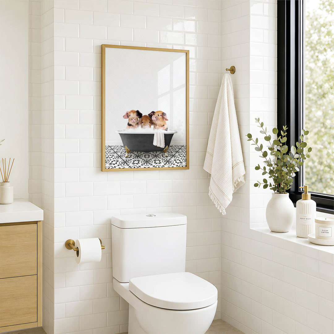 A modern bathroom with a white toilet, a framed picture of two dogs in a bathtub, and a window with greenery on the sill.