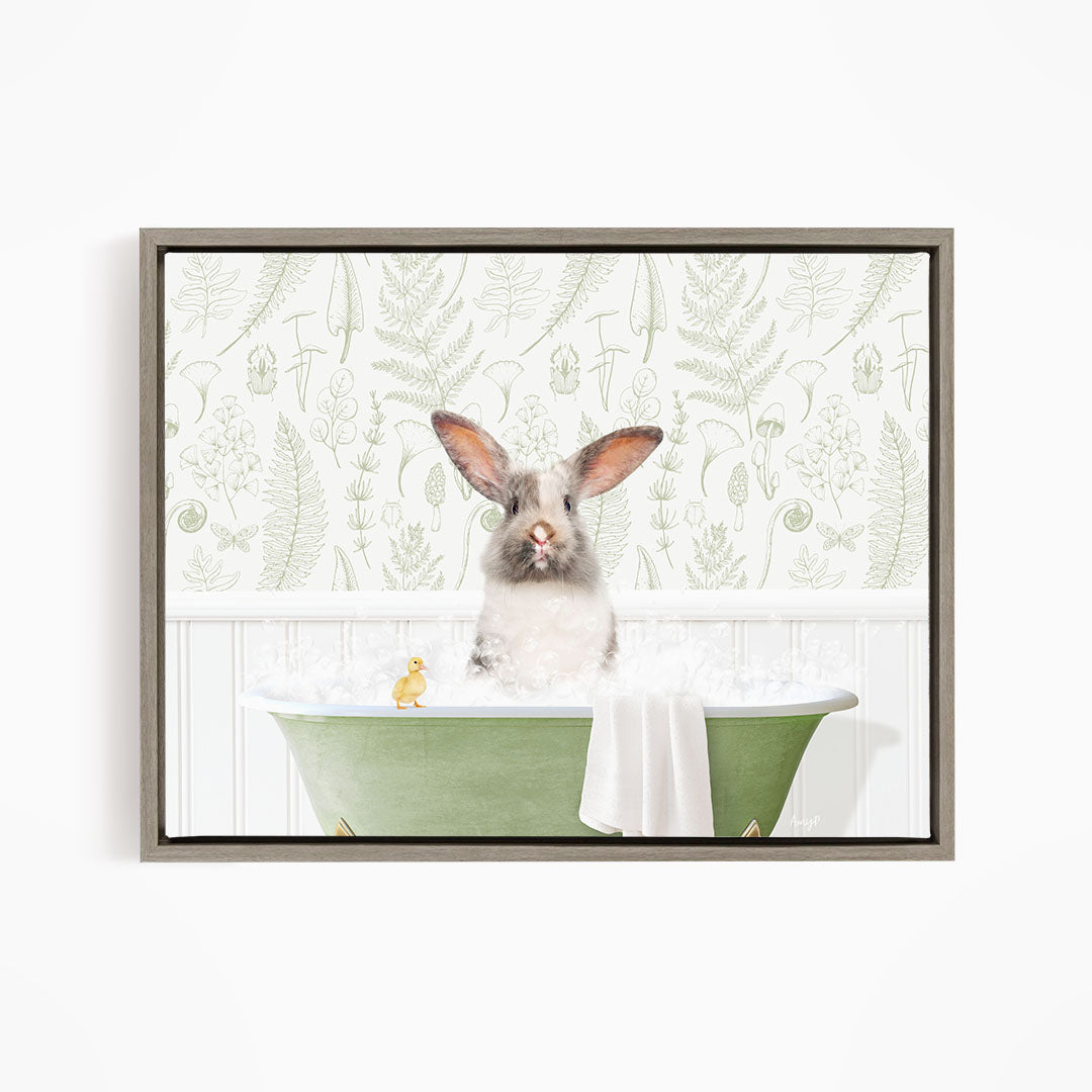 A fluffy white rabbit sits in a green bathtub filled with bubbles, with a yellow rubber duck floating nearby.