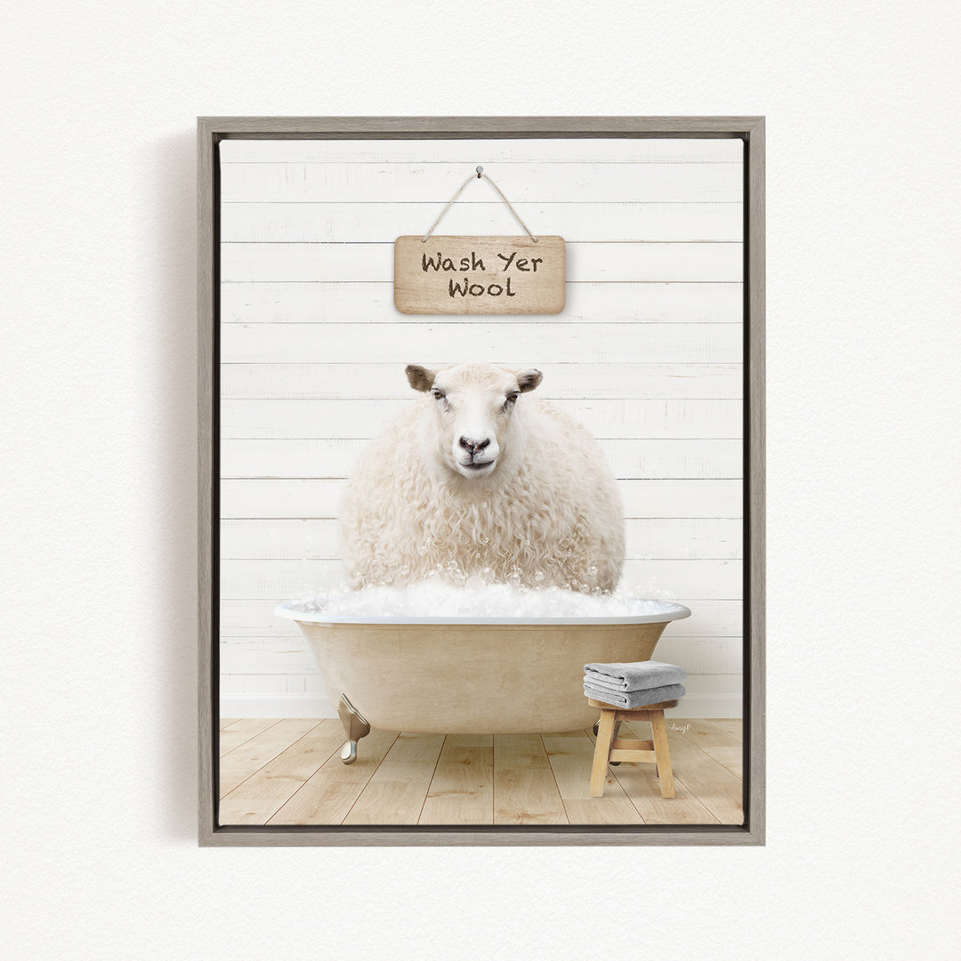 A fluffy white sheep is sitting in a bathtub filled with water, with a sign above it that says "Wash Yer Wool".