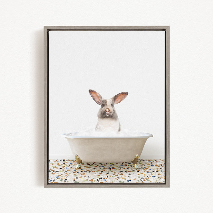 A white rabbit sitting in a white bathtub filled with water, with its head poking out of the tub.