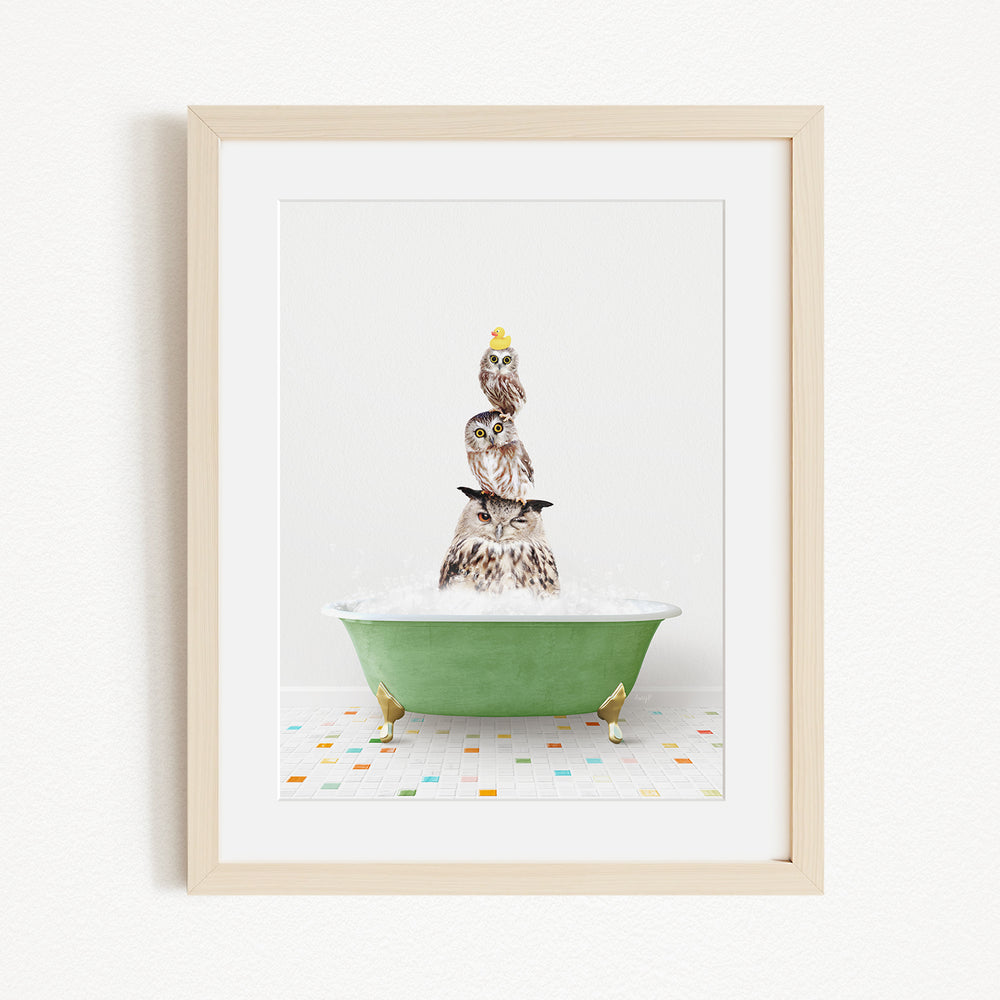 A framed image depicting a group of owls sitting in a green bathtub filled with water, creating a whimsical and playful scene.