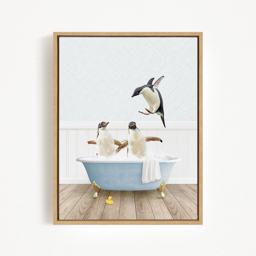A framed image depicting two penguins sitting in a bathtub, with one penguin flying towards the other.