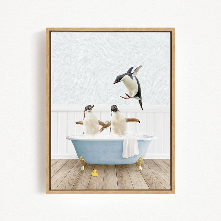 A framed image depicting two penguins sitting in a bathtub, with one penguin flying towards the other.