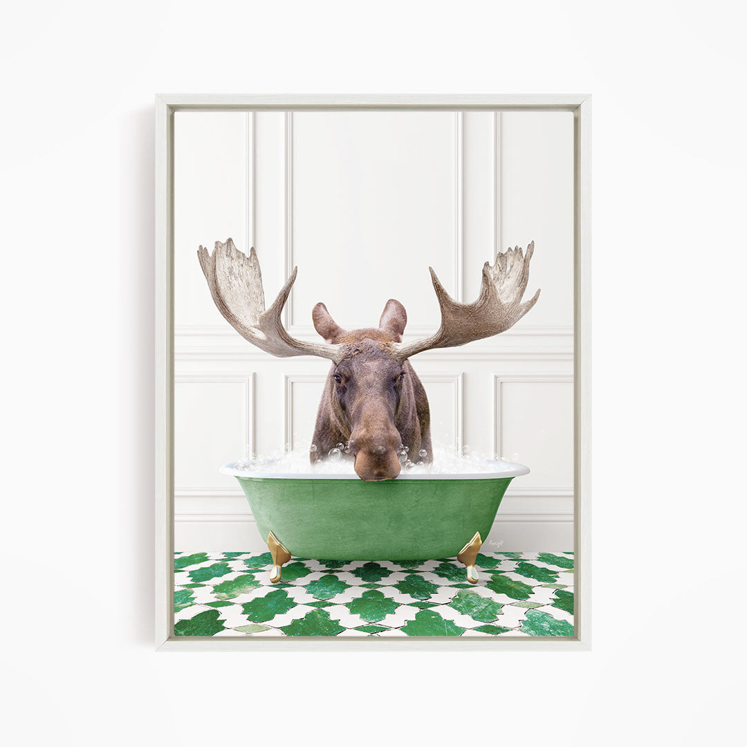 A moose with large antlers is sitting in a green bathtub filled with water, surrounded by a green and white patterned floor.
