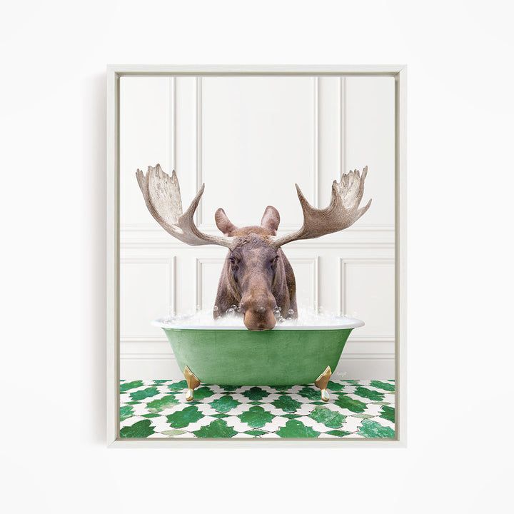 A moose with large antlers is sitting in a green bathtub filled with water, surrounded by a green and white patterned floor.