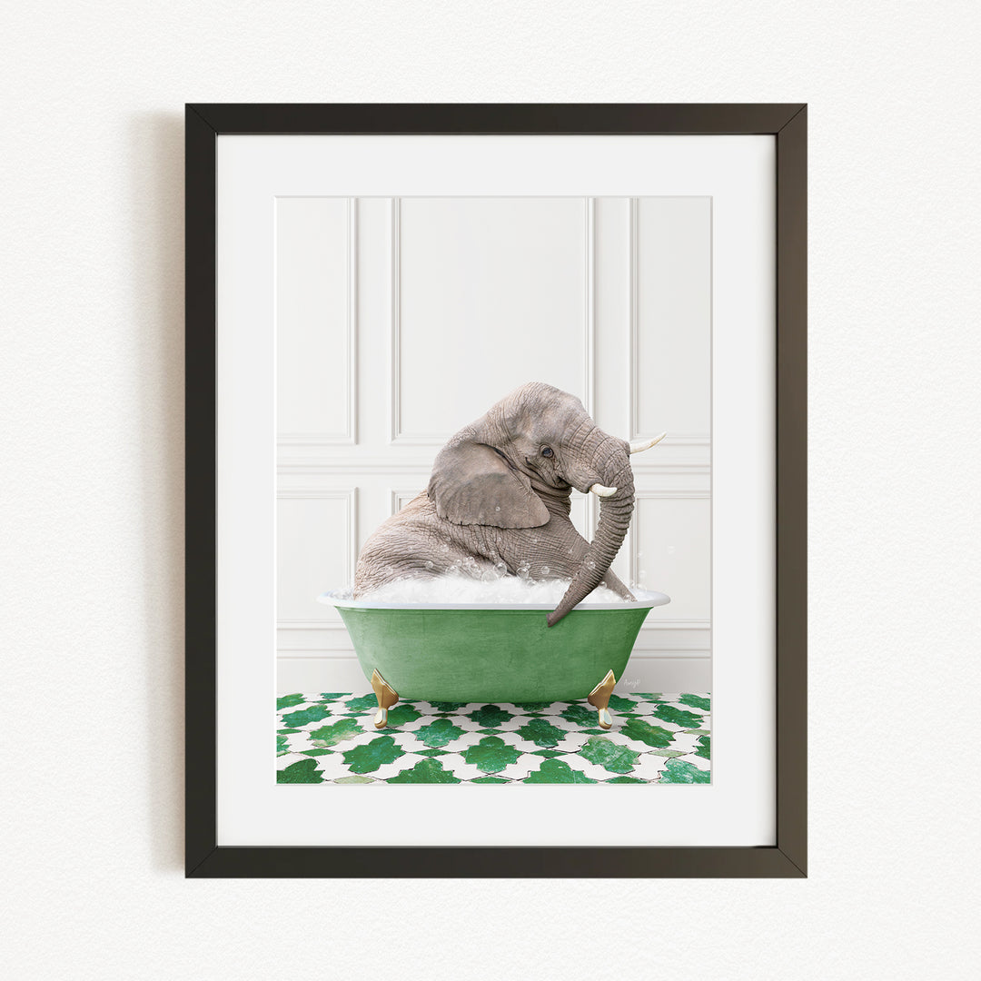 A gray elephant is sitting in a green bathtub filled with water, surrounded by a green and white patterned rug.