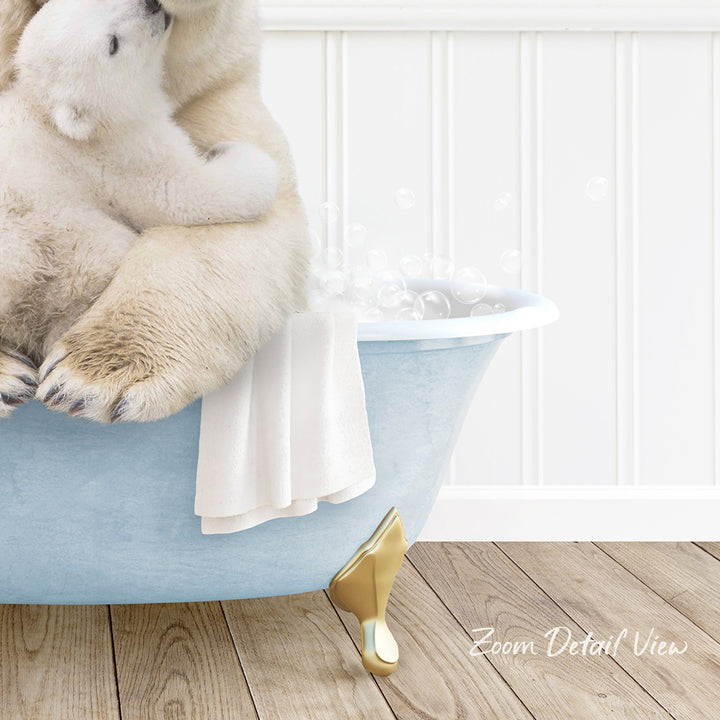 A polar bear sitting in a blue bathtub, surrounded by bubbles, with a towel and gold bathtub leg visible.