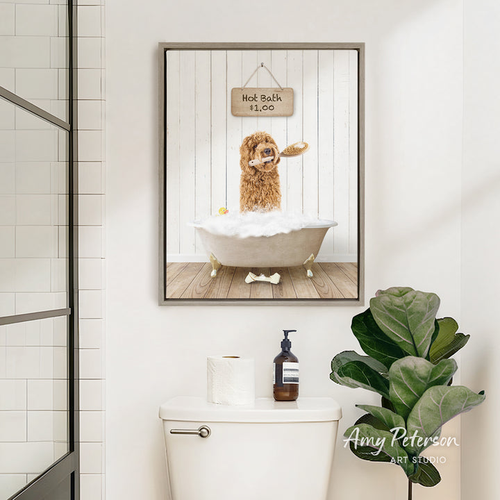 A framed image of a dog sitting in a bathtub, with a sign above it that says "Hot Bath is Fun". The image also includes a toilet and a potted plant in the bathroom.