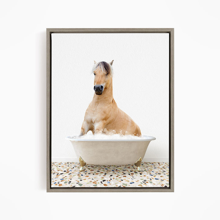 A light brown horse is sitting in a white bathtub filled with water, creating a whimsical and playful scene.