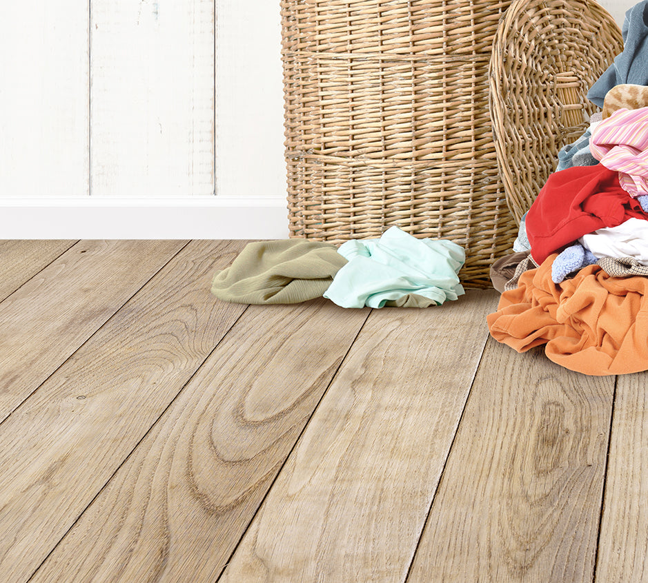 a pile of clothes sitting on top of a wooden floor