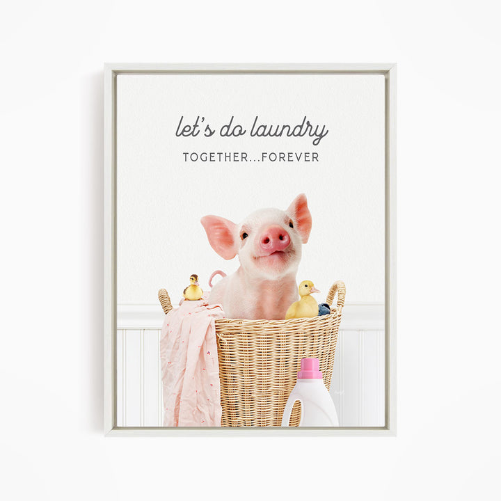 A cute pig sitting in a wicker basket filled with toys, with the text "let's do laundry together forever" displayed above the image.