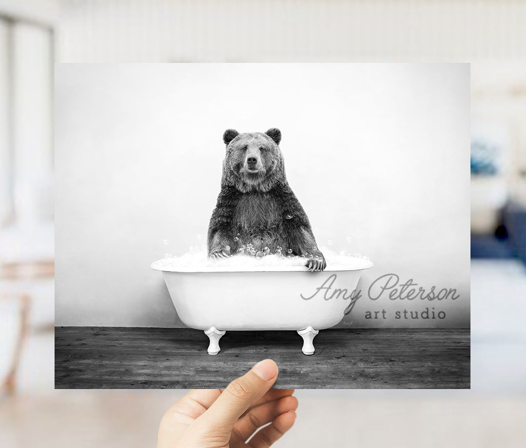 a black and white photo of a bear in a bathtub