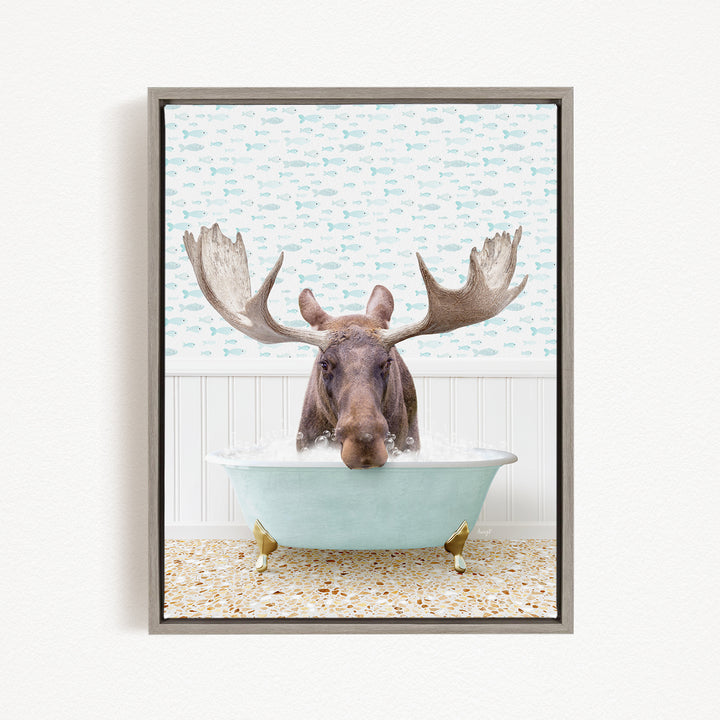A moose with large antlers is sitting in a bathtub filled with water, surrounded by a pattern of fish.