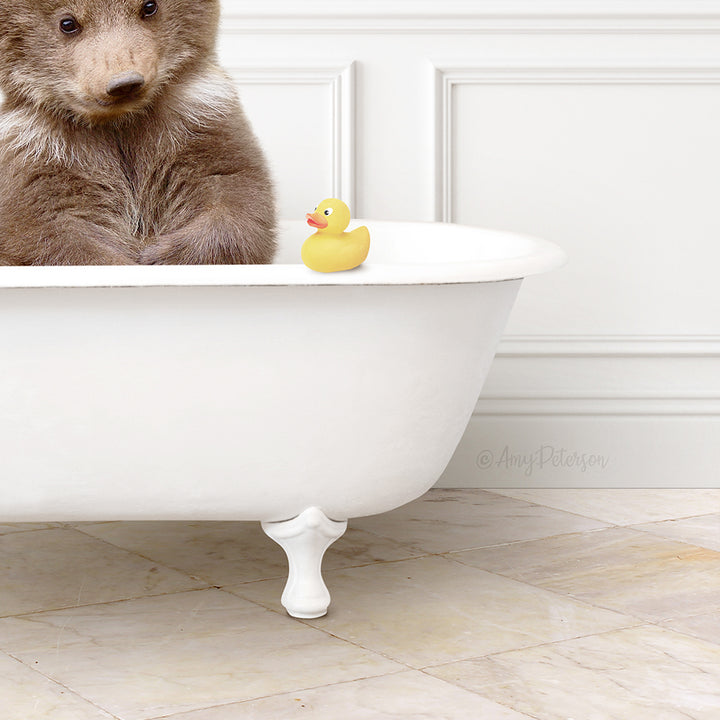 A brown bear sits in a white bathtub, with a yellow rubber duck resting on the edge of the tub.