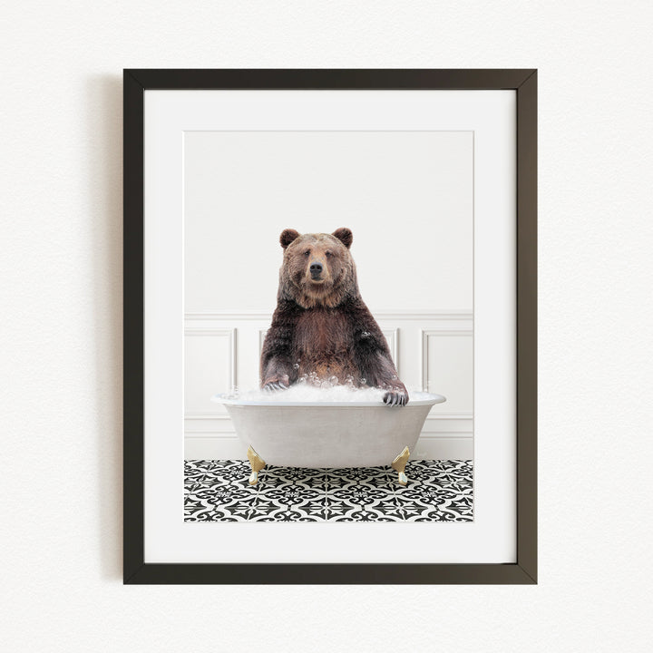 A brown bear sitting in a white bathtub filled with water, creating a whimsical and humorous scene.