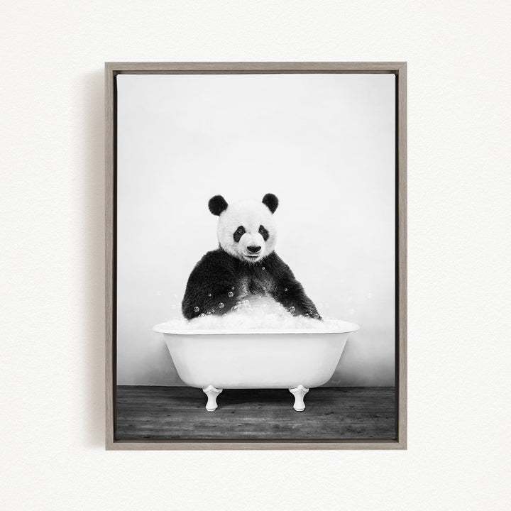 A panda bear sitting in a white bathtub filled with bubbles, appearing to enjoy a relaxing bath.