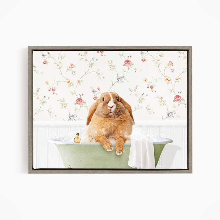 A brown rabbit sitting in a green bathtub filled with water, surrounded by a floral wallpaper.