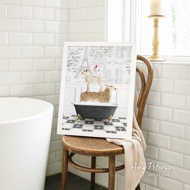 A framed image of a dog sitting on a bathtub filled with bubbles, with a towel draped over the back of a wooden chair in a bathroom setting.