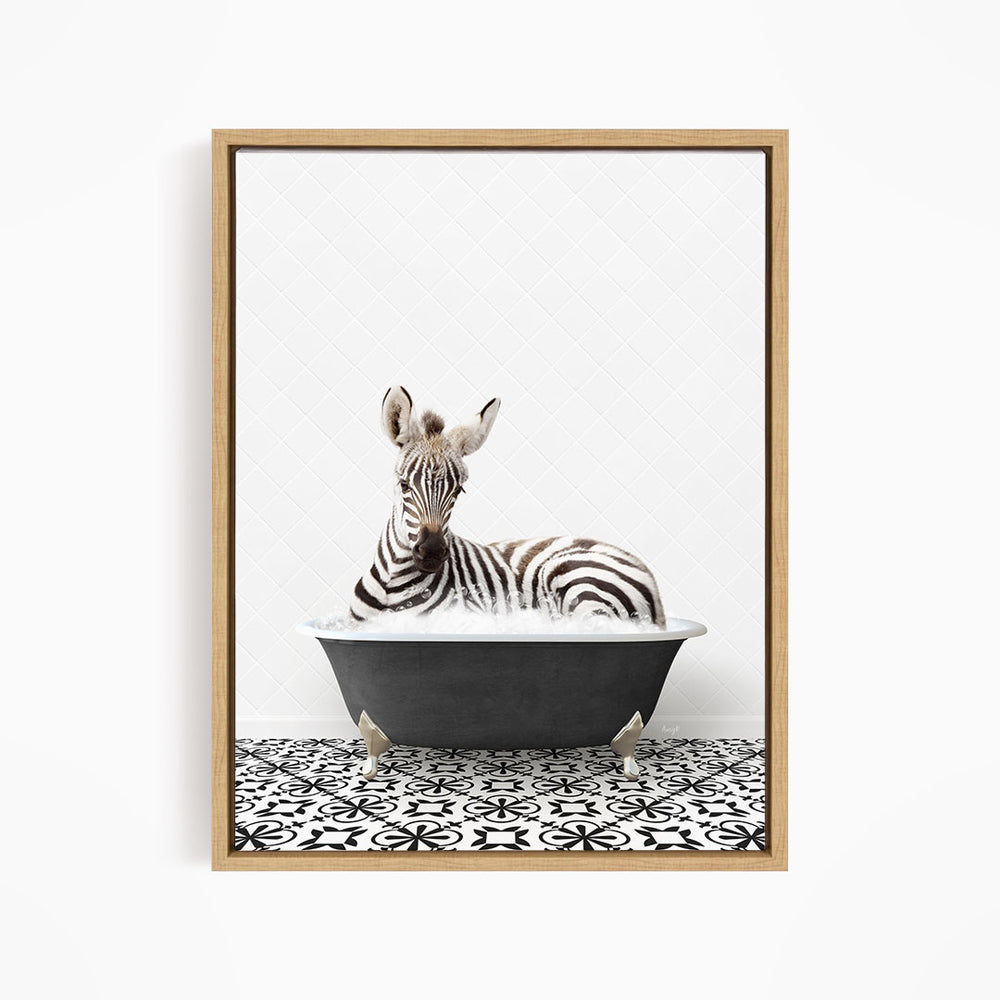 A zebra is sitting in a bathtub filled with water, surrounded by a black and white patterned floor.