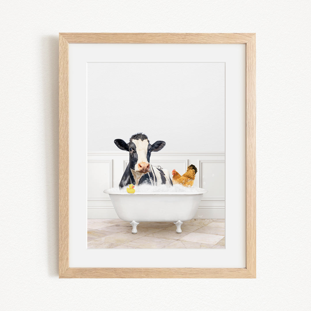 A black and white cow is sitting in a white bathtub, surrounded by a yellow rubber duck and a chicken, creating a whimsical and playful scene.