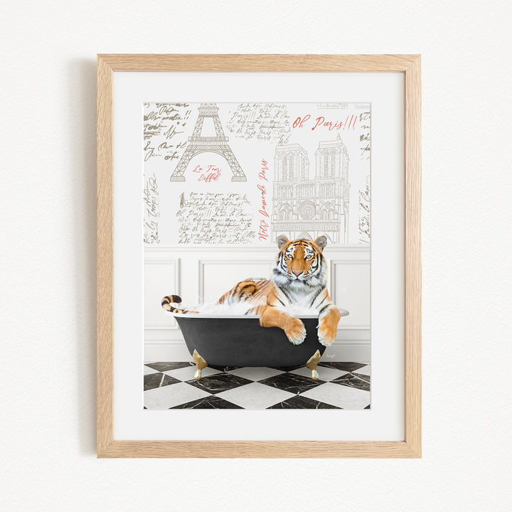A framed image depicting a tiger sitting in a bathtub, with a Paris-themed background featuring the Eiffel Tower and other Parisian landmarks.